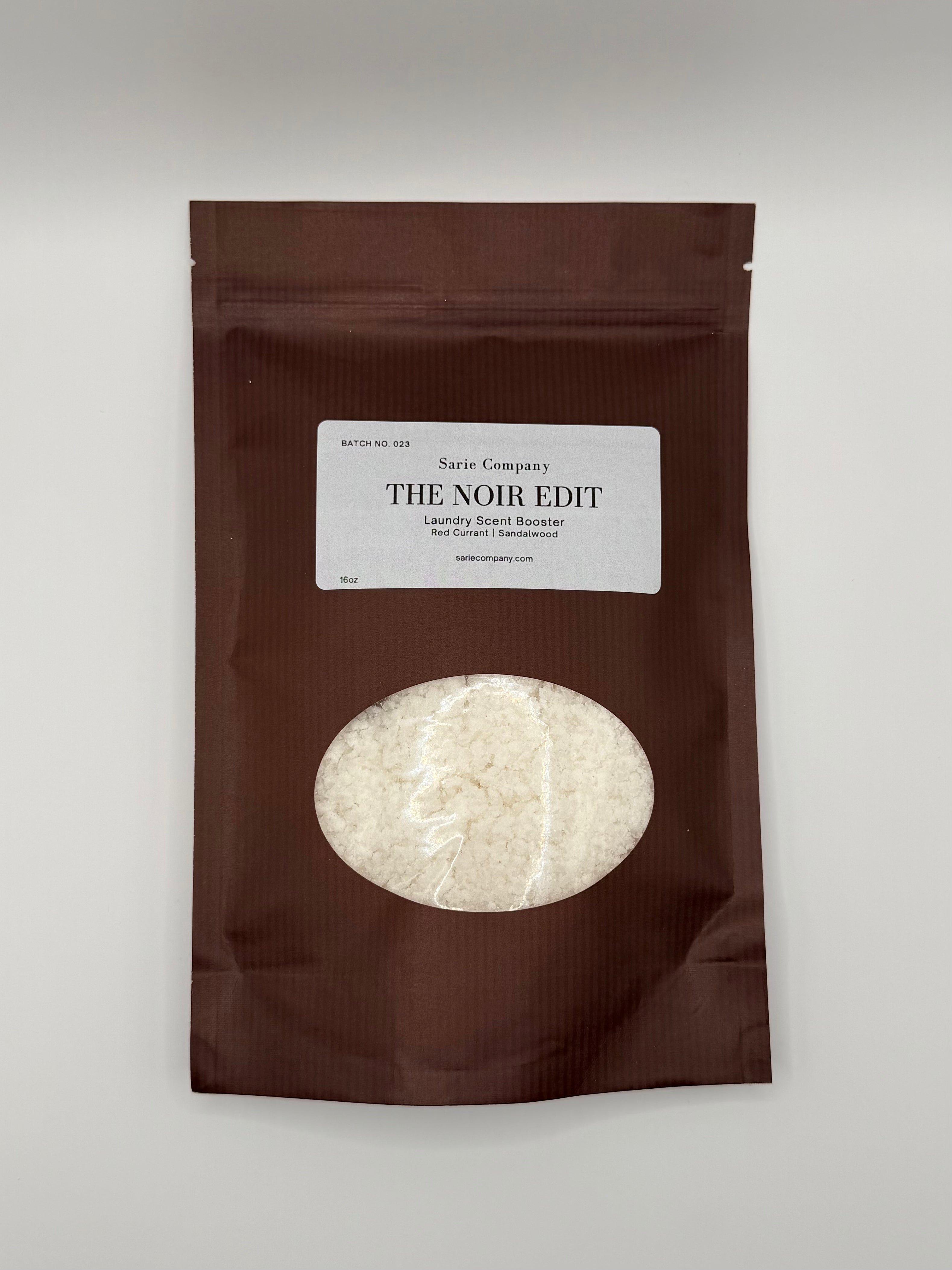 Brown packaging of 'The Noir Edit' with a white label on a white background