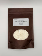 Brown package of 'The Vanilla Edit' laundry scent booster with visible product inside on a white background.