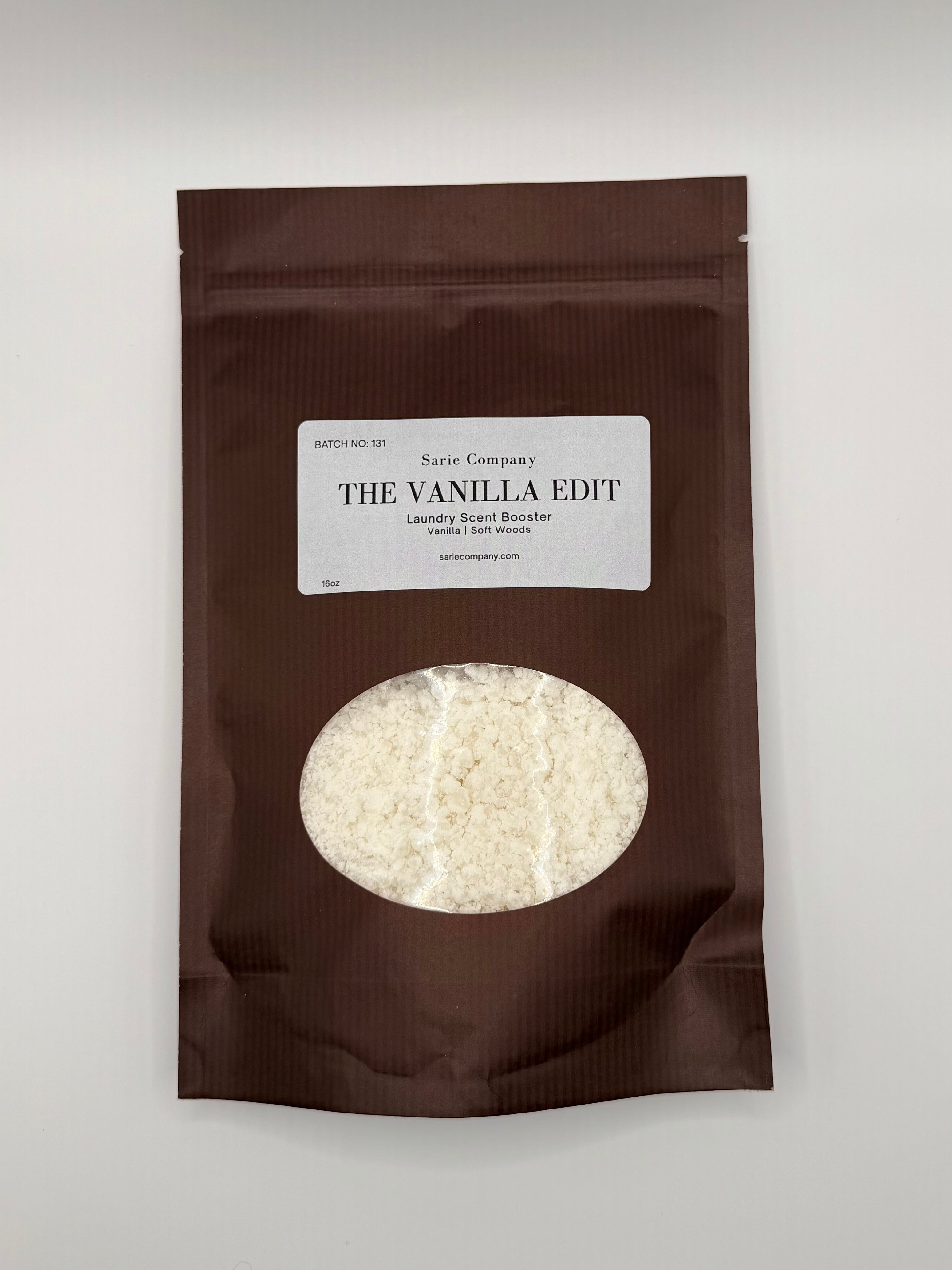Brown package of 'The Vanilla Edit' laundry scent booster with visible product inside on a white background.