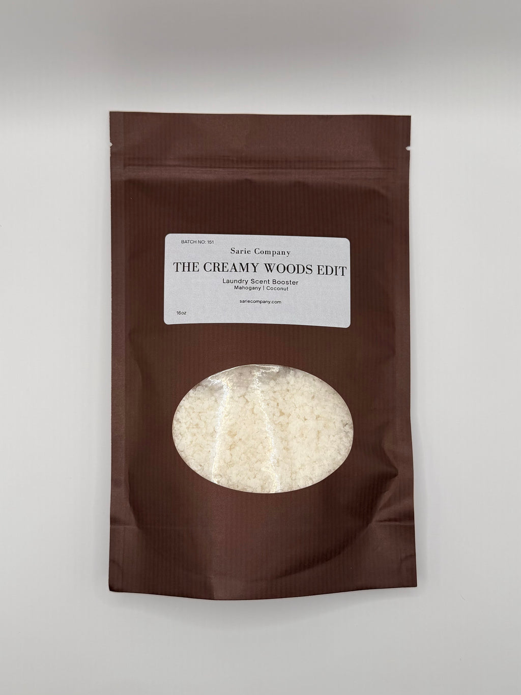 Brown package with a label titled 'The Creamy Woods Edit' on a white background.