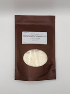 Brown package with a label titled 'The Creamy Woods Edit' on a white background.