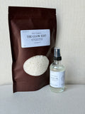 A room spray and laundry scent booster from Sarie Company's Glow Edit displayed  on a white background.