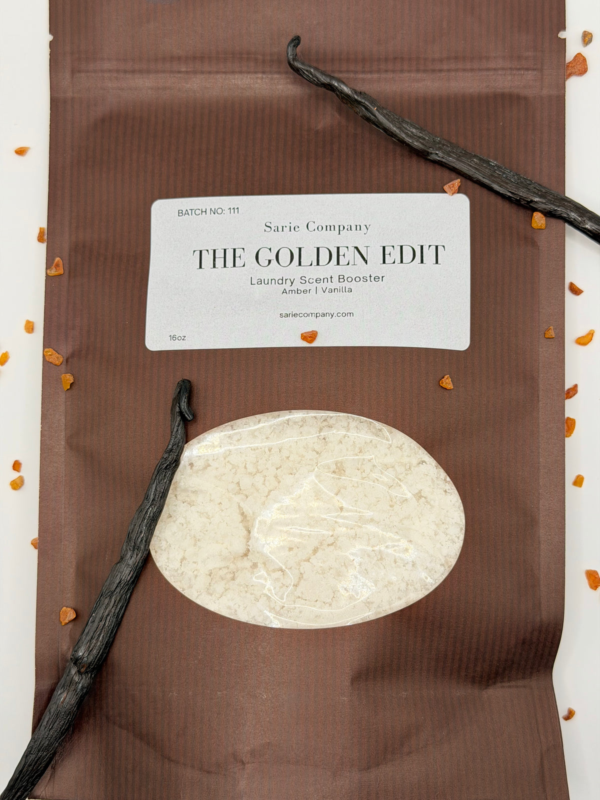 Sarie Company laundry scent booster package with vanilla beans and a vanilla pod on a white background