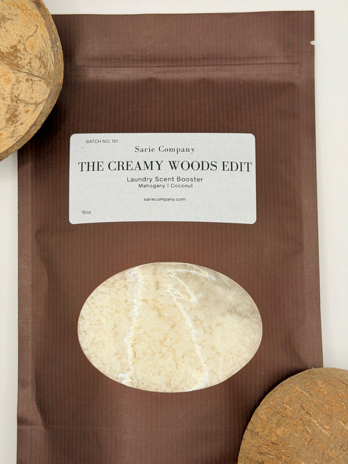 Brown package with a label for 'The Creamy Woods Edit' by Sarie Company on a white background with coconuts on each side.